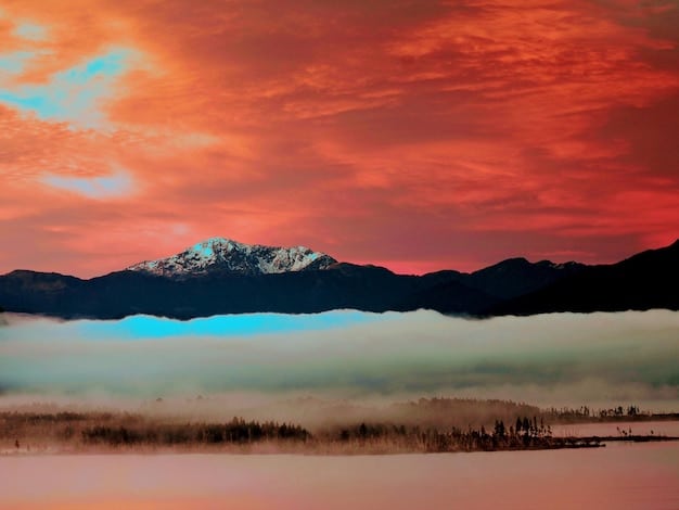 A serene natural landscape during sunset, with mountains in the distance, symbolizing peace and a sense of wonder.