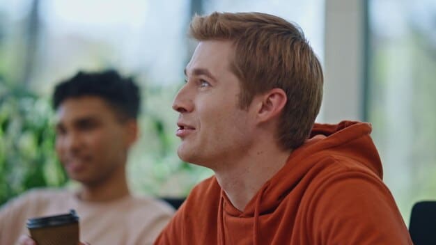 A close-up shot of a person listening intently with a slight smile, eyes focused on the speaker, conveying attentiveness and understanding.