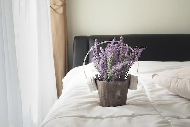 A bedroom featuring a soft color palette of blues and grays. The bed is dressed with linen bedding, and there's a wooden bedside table with a simple lamp and a small vase of lavender.