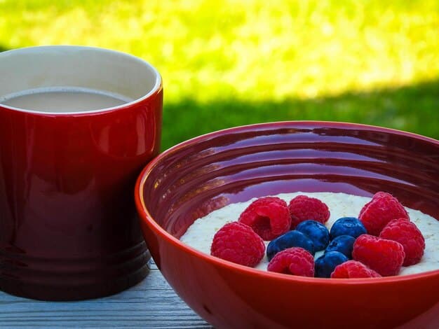 A vibrant image of a bowl filled with Greek yogurt topped with a mix of fresh berries (strawberries, blueberries, raspberries), with a spoon resting in the bowl.