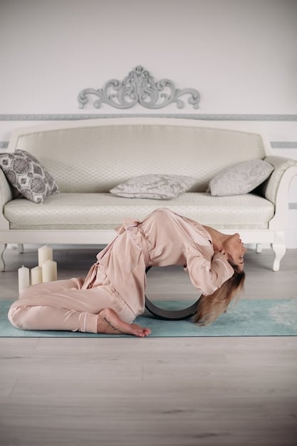 A person lying on their back on a yoga mat, eyes closed, with a blanket covering them. Soft, natural light floods the room, creating a peaceful and serene atmosphere.