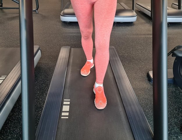 A close-up of a person's legs and feet walking on a treadmill in a gym setting, focusing on the movement and the digital display showing time and distance.
