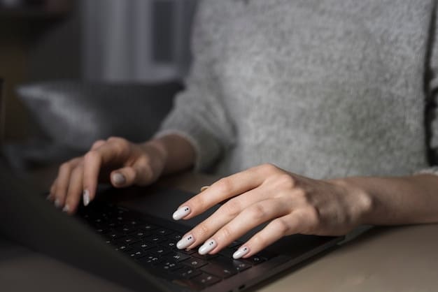 A close-up shot of a hand typing on a laptop keyboard, with a focus on the fingers and keys. The soft lighting highlights the texture of the keyboard and suggests a productive, focused work session.