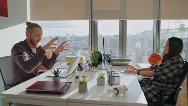 A supervisor having a one-on-one conversation with an employee in a bright, modern office setting, discussing work-life balance and stress management strategies.
