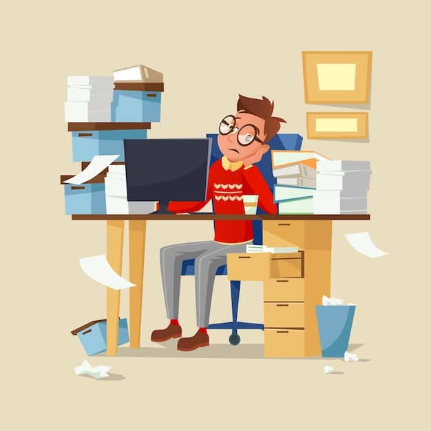 An individual sitting at a desk covered with papers and multiple devices, looking overwhelmed and stressed, illustrating overcommitment and lack of work-life balance.