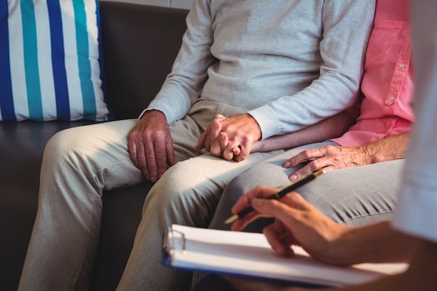 A close-up shot of a caregiver with a notebook and pencil in hand, sitting and listening attentively to an elderly person as they discuss their health concerns and needs in a sunlit room.
